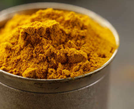 curcuma spice in metal bowl macro shot soft focusの写真素材