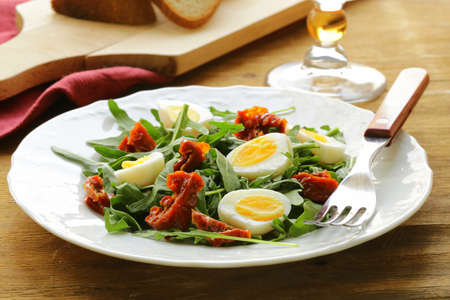 salad with sun dried tomato and quail eggsの写真素材