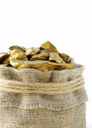 gold nuggets in a linen bag on a white backgroundの写真素材