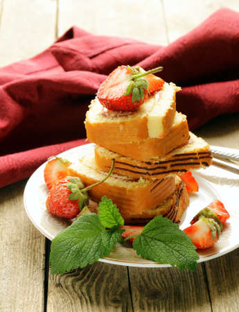 roulade cake with cream and strawberries