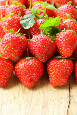 lots of fresh ripe strawberries on a wooden board