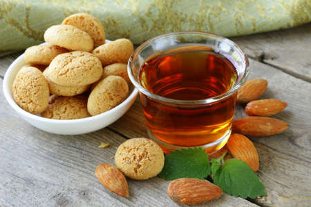Dessert liqueur Amaretto with almond biscuits  amarittini  and nutsの写真素材