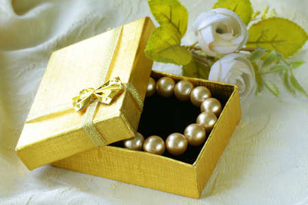 pearl necklace in a gold gift boxの写真素材