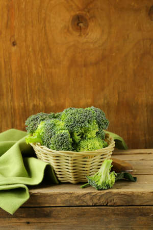 fresh raw green cabbage broccoli in a wicker basketの写真素材