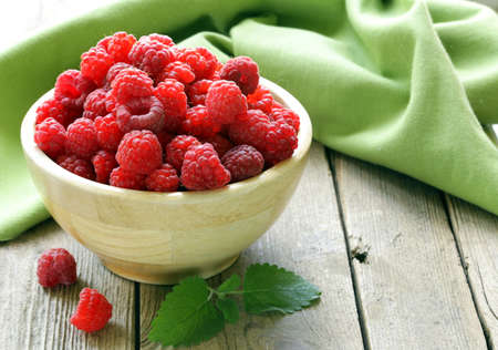 fresh organic ripe berry raspberry on a wooden tableの写真素材