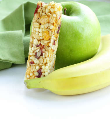 granola bar, green apple and banana - healthy eatingの写真素材