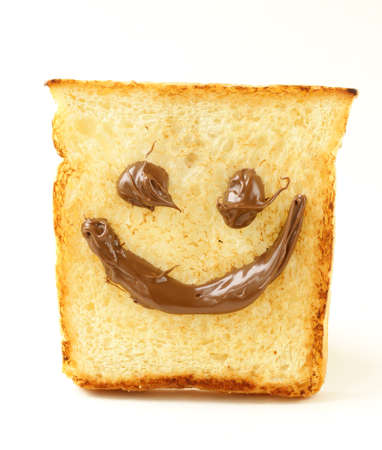 funny toast bread with chocolate smile on white backgroundの写真素材