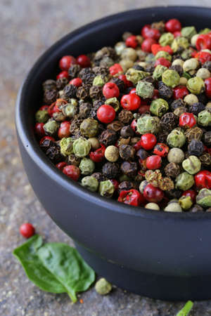 assorted red, black and green pepper in a bowl on the table