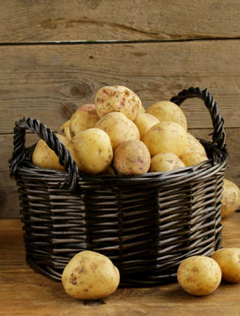 fresh organic potatoes on a wooden background, rustic styleの写真素材