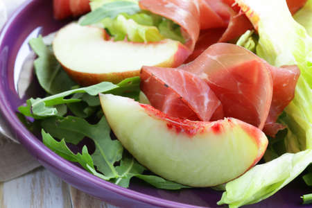 gourmet salad with peaches and bresaola  smoked beef の写真素材
