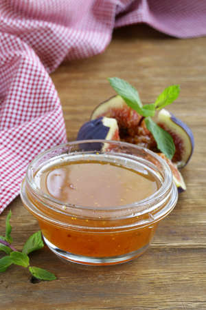 fig jam with fresh berries on the wooden tableの写真素材