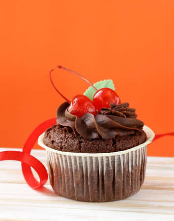 festive  birthday, valentines day  cupcake decorated with chocolate ganache and cherries の写真素材