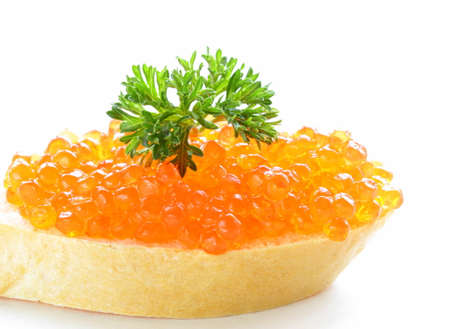 delicacy appetizer red caviar on a white baguetteの写真素材