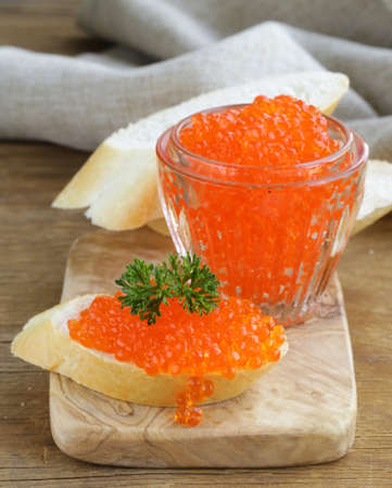 delicacy appetizer red caviar on a white baguetteの写真素材