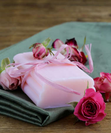 homemade soap with roses on a wooden tableの写真素材