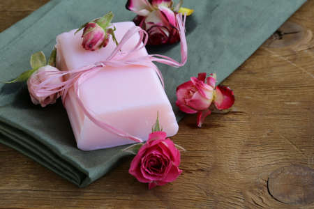 homemade soap with roses on a wooden tableの写真素材