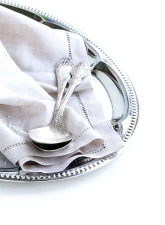 vintage cutlery with old-fashioned napkin on a silver trayの写真素材