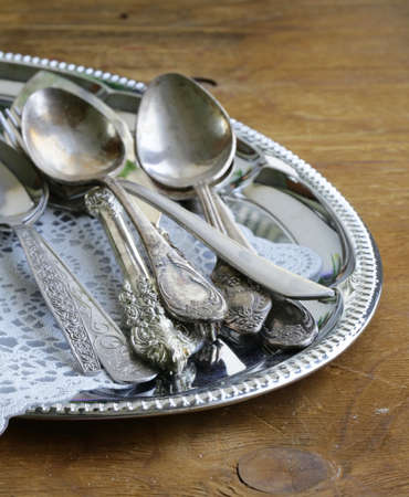 vintage cutlery with old-fashioned napkin on a silver trayの写真素材