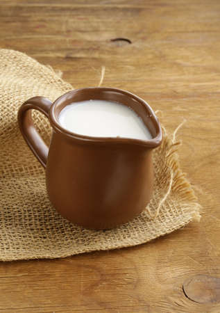 ceramic brown  jug full of milk, rustic styleの写真素材