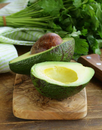 ripe avocado cut in half on a wooden table