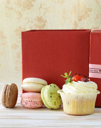 holiday desserts, cupcakes and macaroons on a vintage backgroundの写真素材