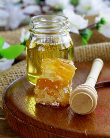 natural organic honey in the comb and  glass jarの写真素材