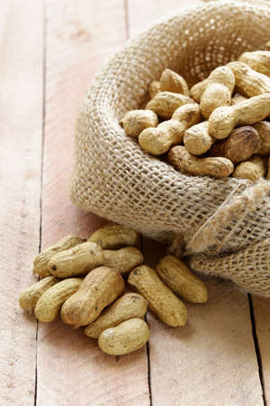 peanuts nuts  in a bag on wooden table