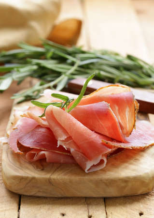 parma ham  jamon  sliced on a wooden boardの写真素材