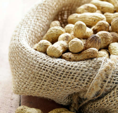peanuts nuts  in a bag on wooden table