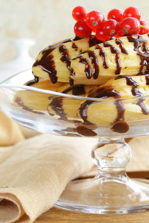 choux pastry eclairs on glass stand base, festive dessert