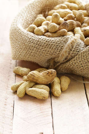 peanuts nuts  in a bag on wooden table