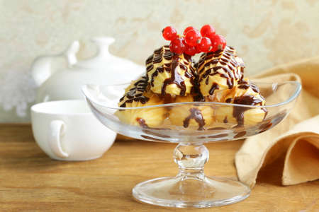 choux pastry eclairs on glass stand base, festive dessert