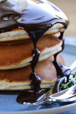 homemade pancakes with chocolate syrup and thymeの写真素材