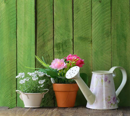 rustic still life watering can, flowers in pots, garden toolsの写真素材