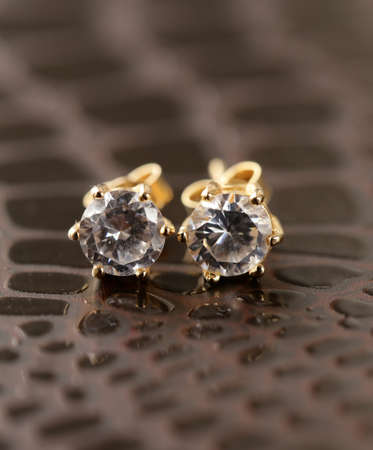 gold earrings stud with diamonds macro shot