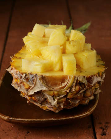 dessert  pineapple sliced  on a wooden plateの写真素材
