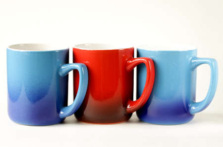 three colorful coffee mugs  blue, red  on a white の写真素材