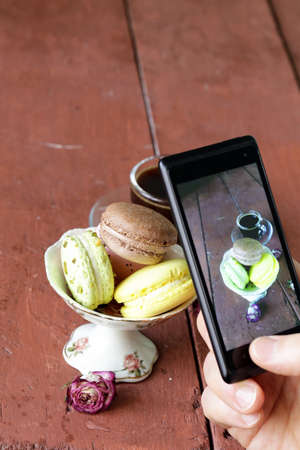 smartphone shot Italian almond macaroons with a cup of espressoの写真素材