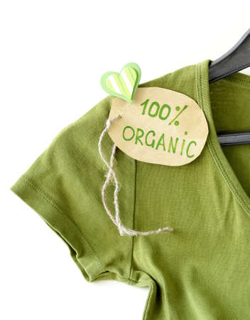 green shirt with organic label on a hangerの写真素材