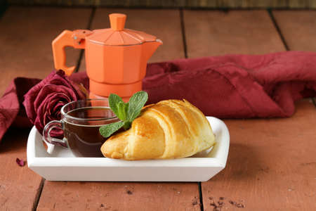 elegant coffee break or breakfast cup of coffee and croissantの写真素材