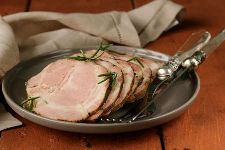 roasted pork neck with black pepper and herbs