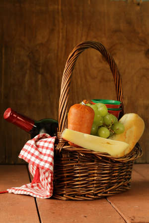 picnic basket - wine, fruit, cheese and sausageの写真素材