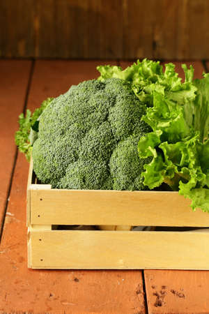 broccoli cabbage and lettuce in a wooden boxの写真素材