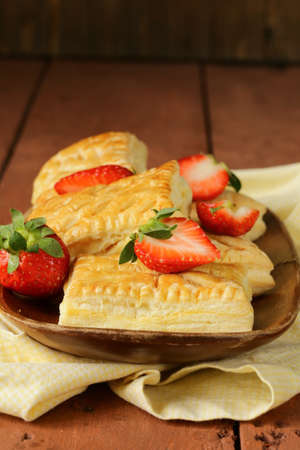 dessert patties puff pastry with strawberries on wooden tableの写真素材