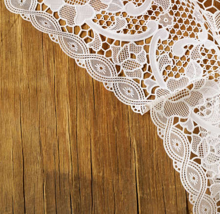 old wooden table with white lace napkinの写真素材