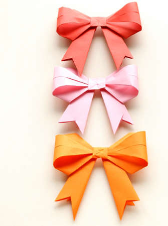 colored paper origami bows for holiday cardsの写真素材