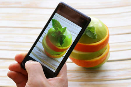 smartphone shot food photo - slices green apple and orangeの写真素材