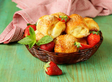 sweet muffins with strawberries and sugar - homemade pastriesの写真素材