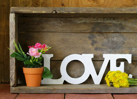 word love made of white wooden letters on vintage backgroundの写真素材