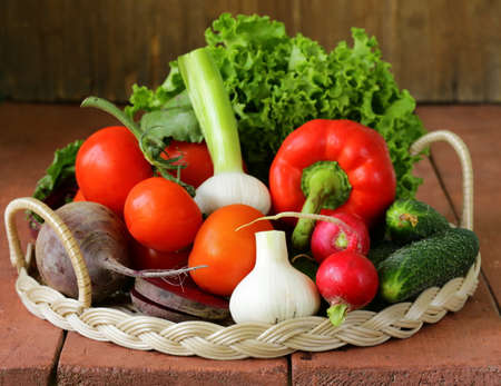 fresh spring vegetables - tomatoes, peppers, garlic, radishes, beetsの写真素材